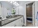 Well-lit bathroom with dual sinks, granite countertops, and a separate shower area at 615 Bourton House Dr, Charlotte, NC 28211