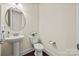 Stylish half bathroom with pedestal sink, dark hardwood floors, and neutral decor at 615 Bourton House Dr, Charlotte, NC 28211