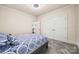 Comfortable bedroom features soft carpet, a ceiling fan, and ample closet space at 615 Bourton House Dr, Charlotte, NC 28211
