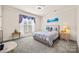 Bright bedroom features neutral walls, soft carpet, and a large window with natural light at 615 Bourton House Dr, Charlotte, NC 28211