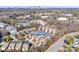 Aerial view of a community with well-maintained homes, mature trees, and views of the city skyline at 615 Bourton House Dr, Charlotte, NC 28211
