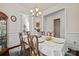 Bright dining room features wainscoting, hardwood floors, and elegant chandelier at 615 Bourton House Dr, Charlotte, NC 28211