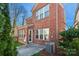 Brick home exterior view featuring a concrete patio and well-maintained landscaping at 615 Bourton House Dr, Charlotte, NC 28211