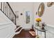 Inviting foyer featuring hardwood floors, staircase, and decorative mirror at 615 Bourton House Dr, Charlotte, NC 28211