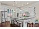 Modern kitchen with white cabinets, granite countertops, and a large center island at 615 Bourton House Dr, Charlotte, NC 28211