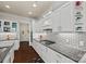 Bright kitchen features white cabinets, granite countertops, and subway tile backsplash at 615 Bourton House Dr, Charlotte, NC 28211