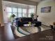 Comfortable living room with plush sofa, stylish rug, and large windows at 615 Bourton House Dr, Charlotte, NC 28211
