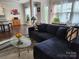 Comfortable living room features plush sofa and large windows for natural light at 615 Bourton House Dr, Charlotte, NC 28211