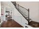 Beautiful staircase with dark wood treads and decorative iron railings at 615 Bourton House Dr, Charlotte, NC 28211