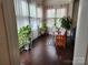 Bright sunroom with plants, natural light, and a charming wooden chair at 615 Bourton House Dr, Charlotte, NC 28211