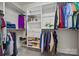 Organized walk-in closet with custom shelving, hanging rods, and ample storage space at 615 Bourton House Dr, Charlotte, NC 28211