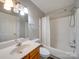 Well-lit bathroom features a shower-tub combination and single sink vanity at 702 Selma Burke Ln, Matthews, NC 28105
