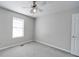 Well-lit bedroom with a window, neutral walls, and cozy carpeting at 702 Selma Burke Ln, Matthews, NC 28105