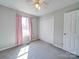 Cozy bedroom with pink curtains and neutral-toned walls at 702 Selma Burke Ln, Matthews, NC 28105
