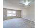 Spacious bedroom with neutral carpet, a ceiling fan and double window allowing for natural light at 702 Selma Burke Ln, Matthews, NC 28105