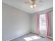 Cozy bedroom with pink curtains, neutral-toned walls, and carpet flooring at 702 Selma Burke Ln, Matthews, NC 28105