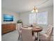 Dining room featuring round table, upholstered chairs, and a modern light fixture at 702 Selma Burke Ln, Matthews, NC 28105
