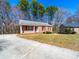 Charming brick home featuring a spacious front yard and a concrete driveway at 702 Selma Burke Ln, Matthews, NC 28105