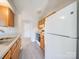 Functional kitchen featuring ample cabinet space and a classic white refrigerator at 702 Selma Burke Ln, Matthews, NC 28105