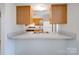 Kitchen view highlighting breakfast bar, cabinetry, countertops, and convenient appliances at 702 Selma Burke Ln, Matthews, NC 28105