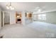 Open floor plan showcasing living area and kitchen with breakfast bar and tile backsplash at 702 Selma Burke Ln, Matthews, NC 28105