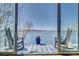 This balcony features two rocking chairs and a blue flower pot overlooking the lake at 7111 Anchorage Ln, Tega Cay, SC 29708