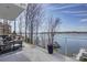 Spacious outdoor balcony with modern furnishings and a stunning view of the lake at 7111 Anchorage Ln, Tega Cay, SC 29708