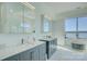 Bright bathroom features dual sinks with granite countertops and views of the lake from the window at 7111 Anchorage Ln, Tega Cay, SC 29708