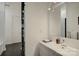 Bright bathroom features a modern vanity, a walk-in shower with black tiled accent wall at 7111 Anchorage Ln, Tega Cay, SC 29708