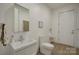 This bathroom features contemporary fixtures, with clean white decor and a modern design at 7111 Anchorage Ln, Tega Cay, SC 29708
