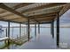 Covered boat dock on the lake with a boat lift offering convenient access to the water at 7111 Anchorage Ln, Tega Cay, SC 29708