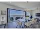 Modern dining room with glass table, sleek chairs, and a view of the waterfront at 7111 Anchorage Ln, Tega Cay, SC 29708