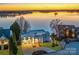 Contemporary home showcasing modern architecture, lush landscaping, and waterfront views at 7111 Anchorage Ln, Tega Cay, SC 29708