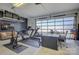 The garage features gym equipment and a functional office space with large picture window for lots of natural light at 7111 Anchorage Ln, Tega Cay, SC 29708