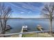 A scenic lake view from a balcony with boat docks, showing the calm waters and surrounding landscape at 7111 Anchorage Ln, Tega Cay, SC 29708