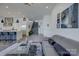 Spacious living room with open staircase, modern kitchen, and comfortable furnishings at 7111 Anchorage Ln, Tega Cay, SC 29708