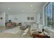 The living room features lake views from a large window and a modern layout perfect for entertaining at 7111 Anchorage Ln, Tega Cay, SC 29708