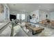 This airy living room features a lake view and open concept with modern finishings and fixtures at 7111 Anchorage Ln, Tega Cay, SC 29708