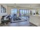 Open-concept living room with lake views and access to the outdoor balcony through large glass doors at 7111 Anchorage Ln, Tega Cay, SC 29708