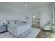 Bright main bedroom boasts hardwood floors, sitting area, and access to additional rooms at 7111 Anchorage Ln, Tega Cay, SC 29708