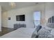 Cozy main bedroom features a door to a balcony overlooking the water and a large TV at 7111 Anchorage Ln, Tega Cay, SC 29708