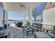 Covered outdoor patio featuring a full outdoor dining set and seating area overlooking stunning lake view at 7111 Anchorage Ln, Tega Cay, SC 29708