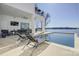 Enjoy a relaxing outdoor space with an in-ground pool and comfortable lounge seating with lake views at 7111 Anchorage Ln, Tega Cay, SC 29708