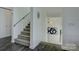 This stairwell is illuminated with modern light fixtures and features sleek contrasting floors and a gray runner at 7111 Anchorage Ln, Tega Cay, SC 29708