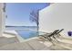 A modern pool overlooks the lake with outdoor lounge chairs and a concrete patio at 7111 Anchorage Ln, Tega Cay, SC 29708