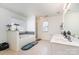 Well-lit bathroom featuring a soaking tub with stylish tile accents, a separate shower, and double sinks at 757 Jones Branch Rd, Fort Mill, SC 29715