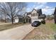 Two-story home featuring a front porch and two-car garage with mature trees and landscaping at 757 Jones Branch Rd, Fort Mill, SC 29715