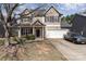 Charming two-story home boasts a two-car garage, welcoming front porch, and manicured landscaping at 757 Jones Branch Rd, Fort Mill, SC 29715