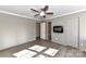 An expansive bedroom showcasing hard surface floors, a ceiling fan, and an electric fireplace at 7804 Renaissance Ct # A, Charlotte, NC 28226