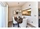 Dining area featuring modern chandelier, a dining table with upholstered chairs, and hardwood style floors at 7804 Renaissance Ct # A, Charlotte, NC 28226
